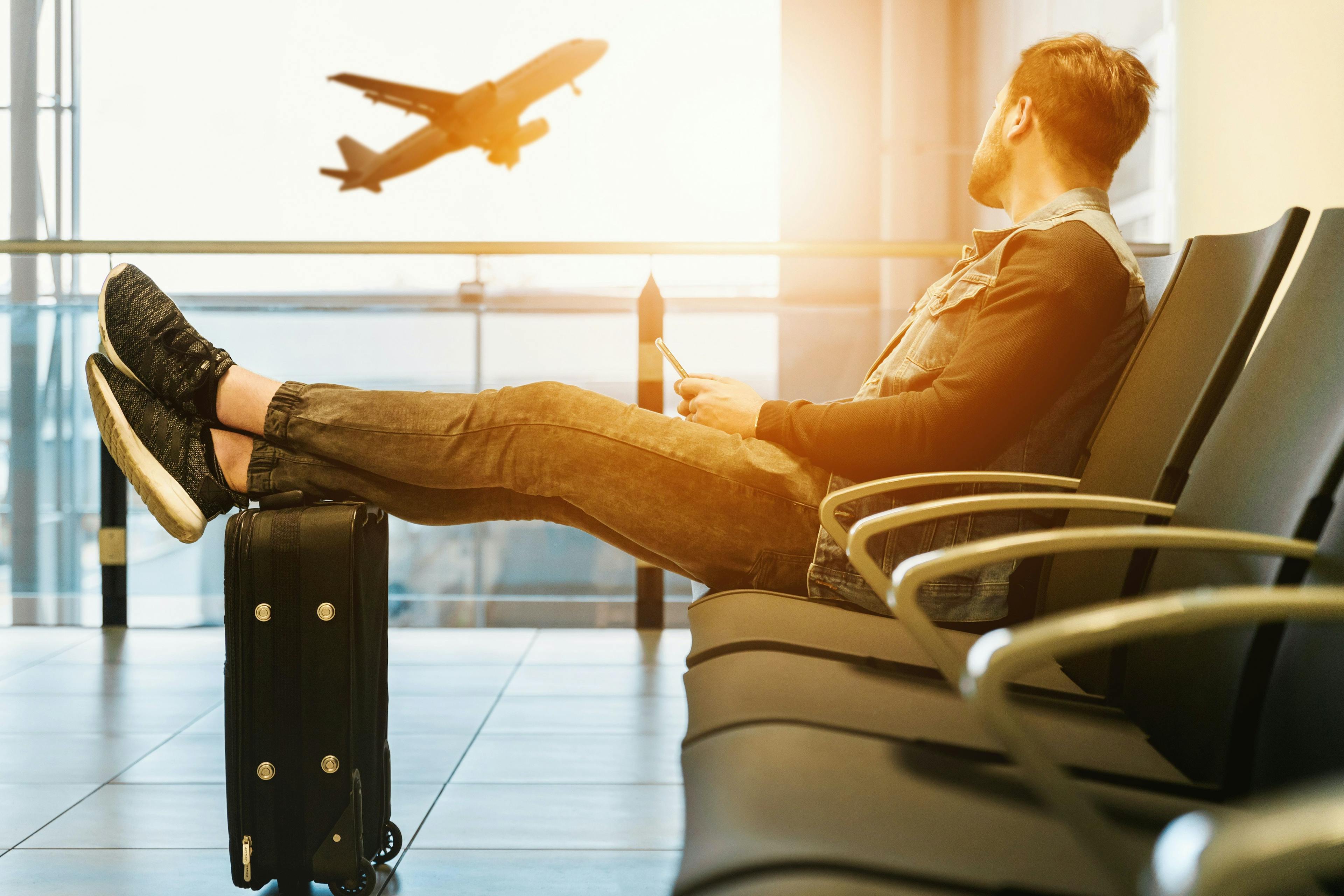 airport, airplane, taking off, man, luggage, suitcase, sun, sunset.